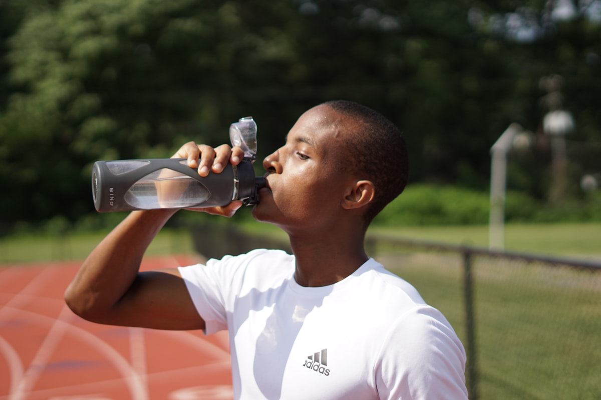 Cyclist refreshing with water during intense cycling session